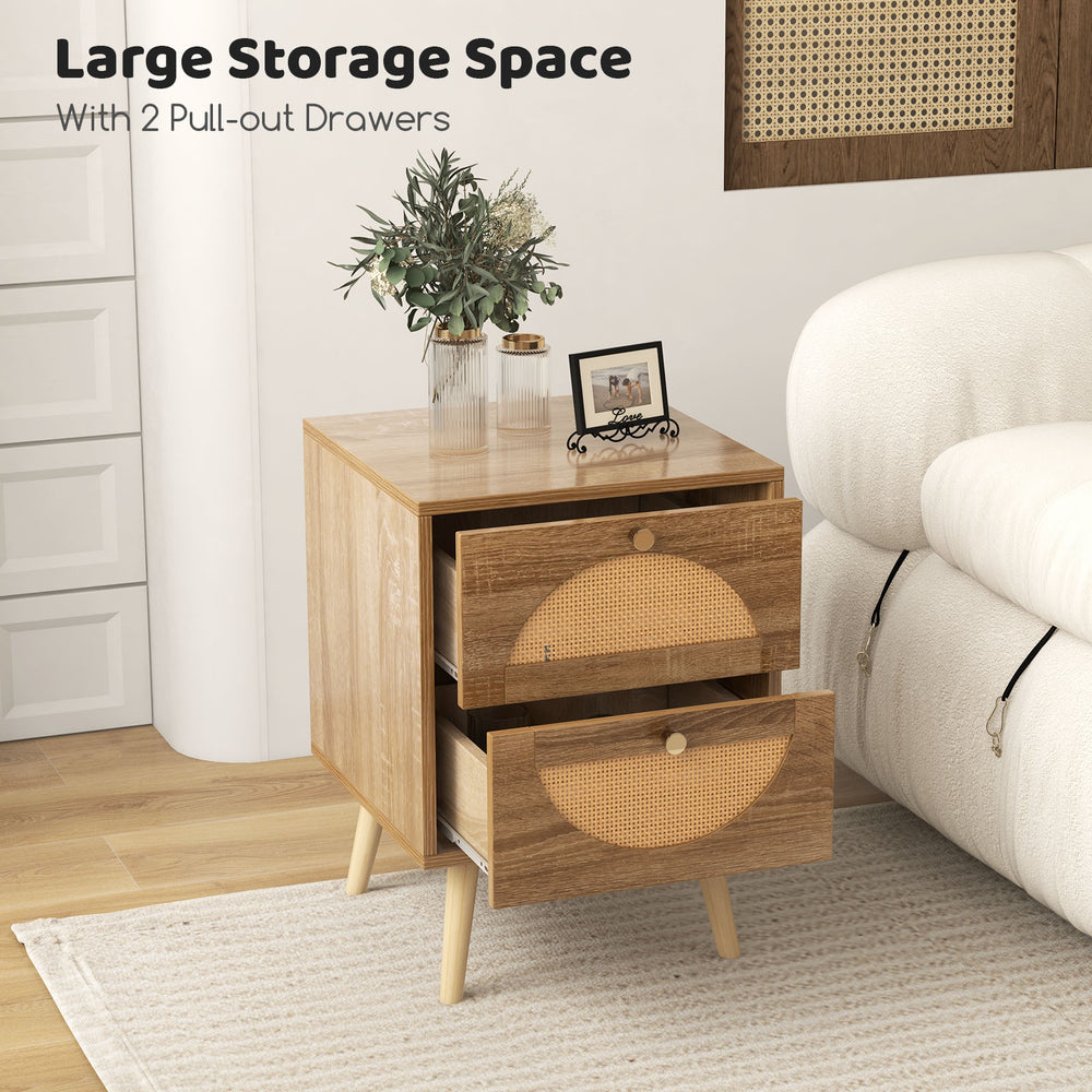 Rattan nightstand with two pull-out drawers and solid wood legs, perfect for stylish bedroom storage.