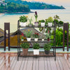 3-tier metal plant stand shelf displaying various potted plants, perfect for outdoor use on a balcony or garden.