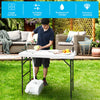 Folding cleaning sink table with sprayer, sturdy plastic surface, ideal for outdoor cleaning and potting tasks.
