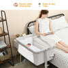Portable beige bedside crib with adjustable heights and detachable sidebar for parent-child interaction and comfort.