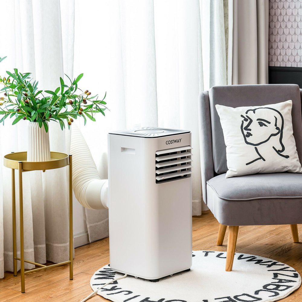 Portable air conditioner in white with remote control, 10000 BTU cooling, placed beside a chair for versatile home use.