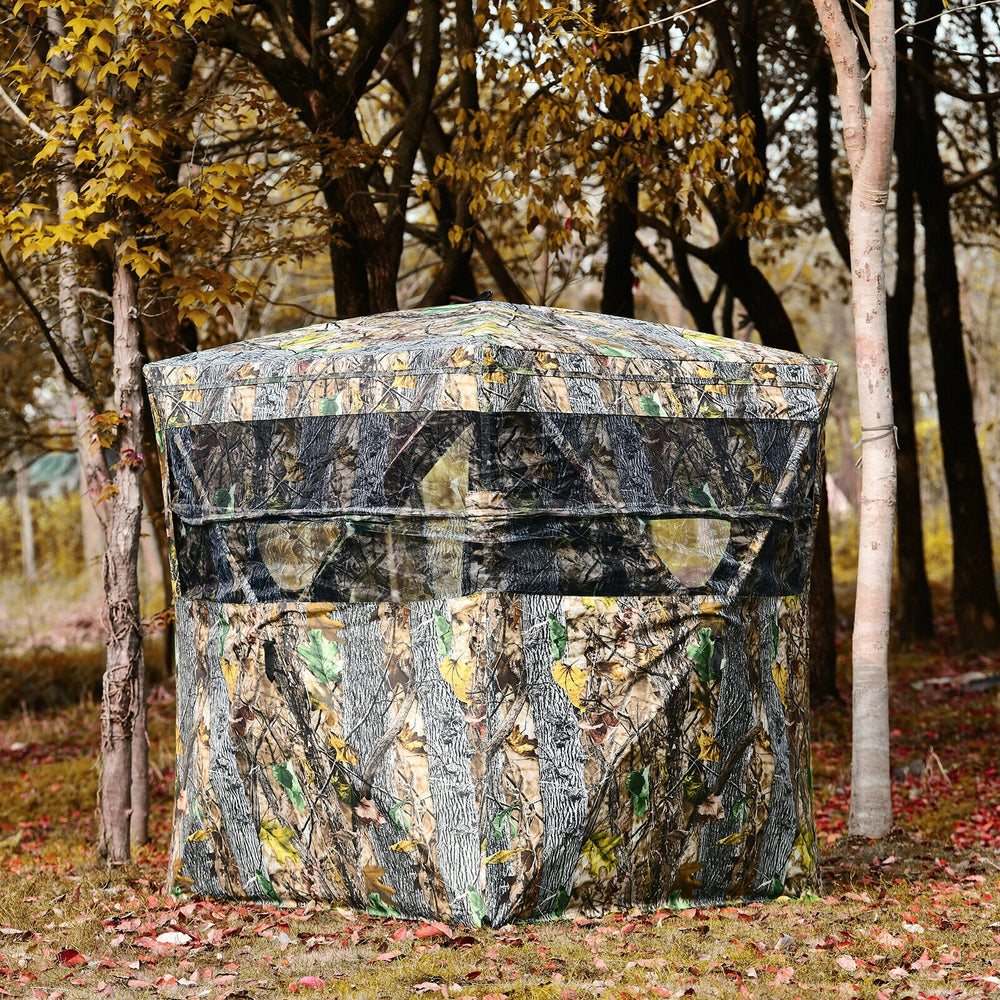 3-person portable tent with camouflage design and mesh windows for enhanced visibility in outdoor settings.