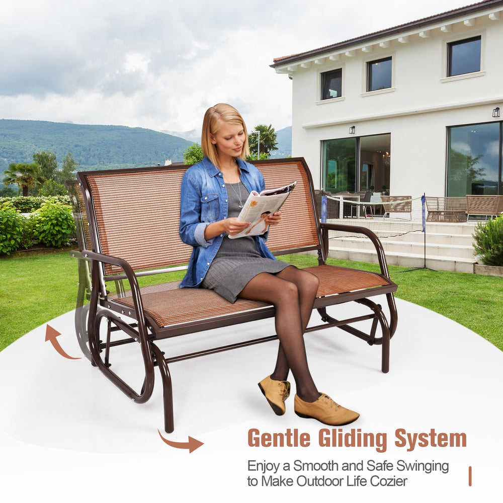 Swing glider chair with brown fabric and sturdy steel frame, ideal for relaxing in outdoor spaces like patios and.