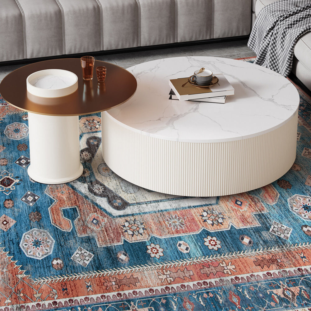 Round coffee table with a marble top and a vintage area rug, perfect for living room or bedroom decor.