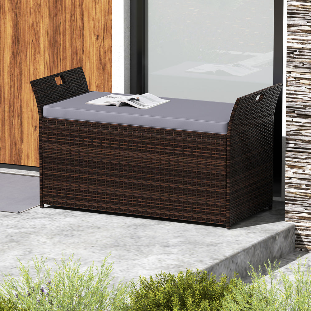 Outdoor bench with hand-woven PE rattan, gray cushion, and side handles, perfect for storage and seating in outdoor.