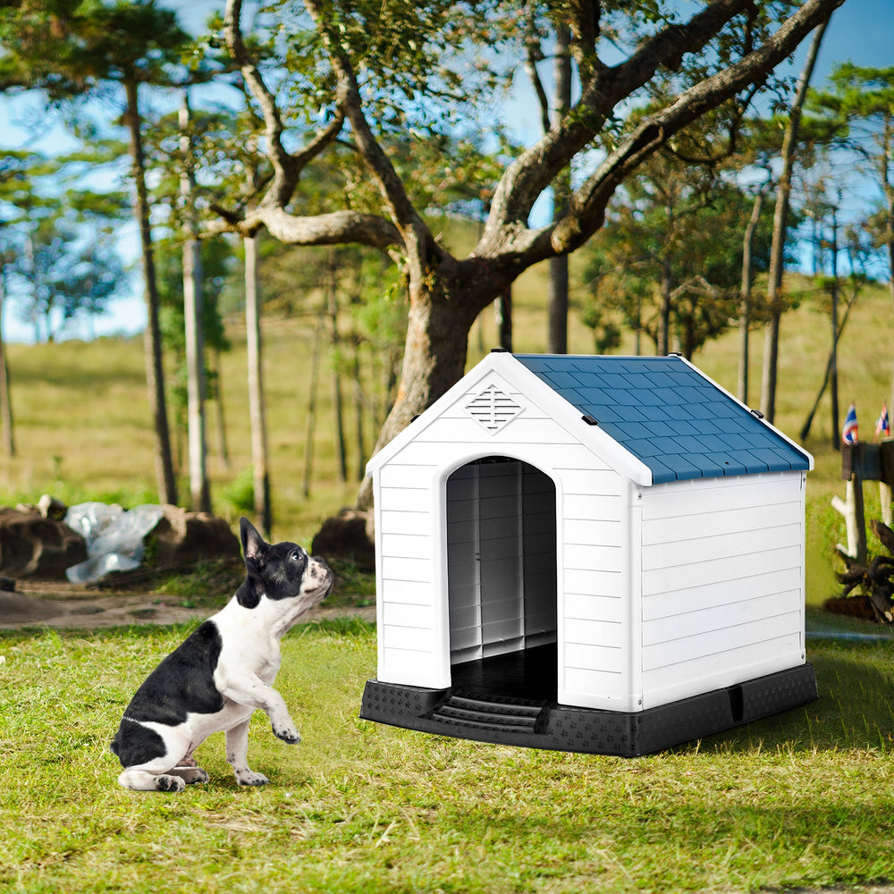 Durable plastic dog house with a ventilated roof, providing a safe outdoor shelter for pets in various weather.