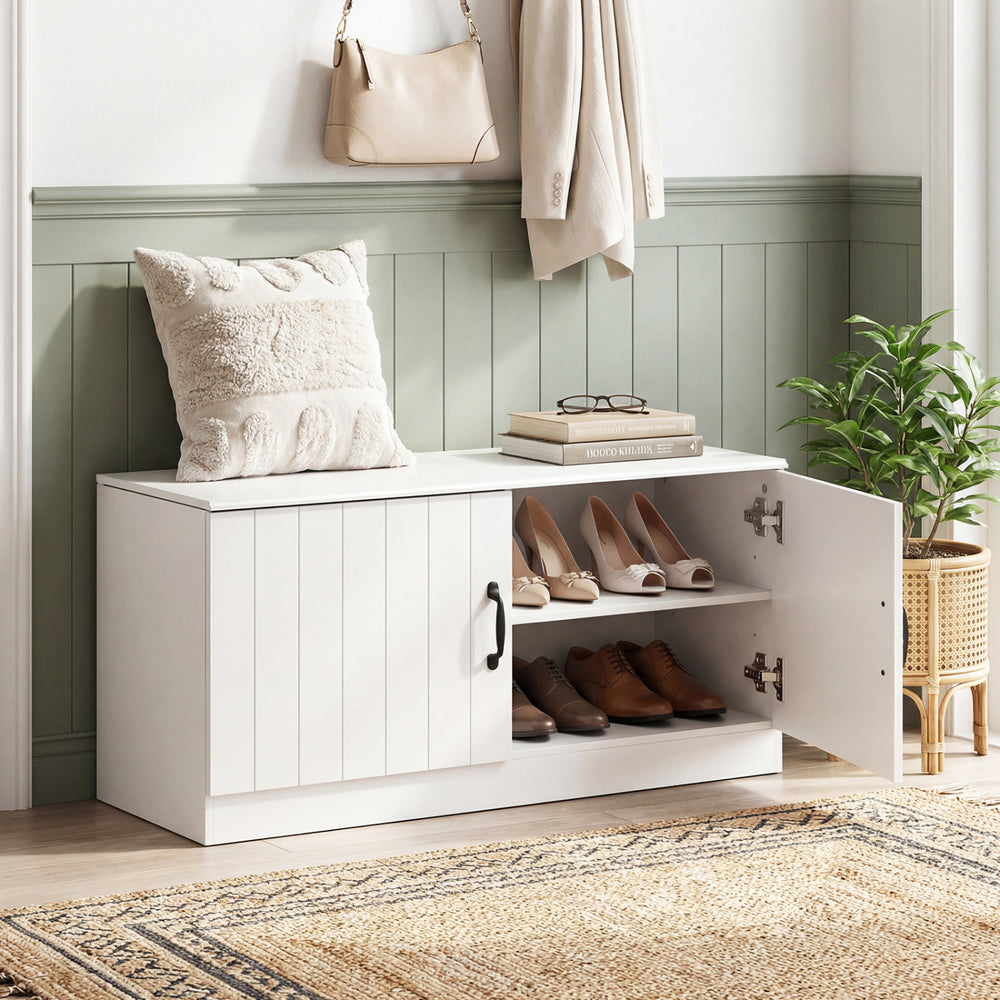 White 2-door shoe storage cabinet with adjustable shelves, providing seating and shoe organization for entryways or.