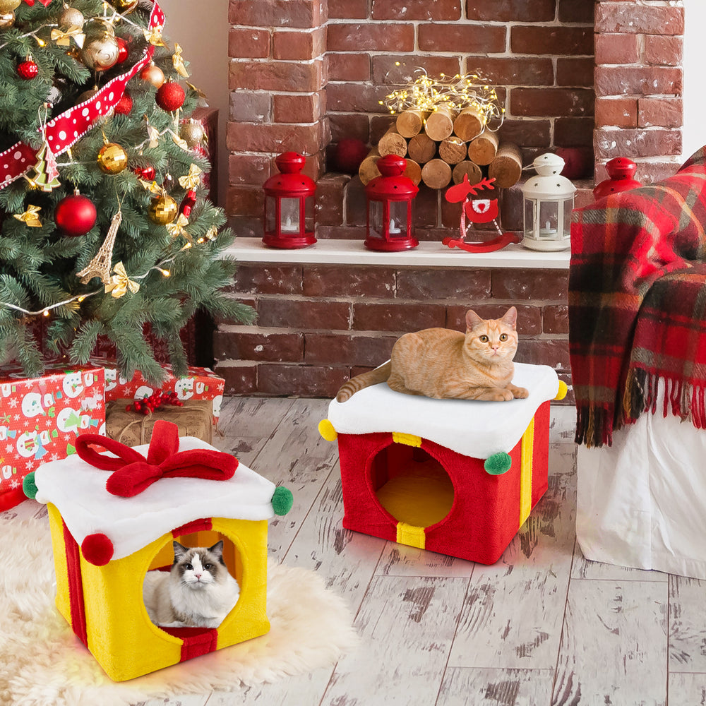 Two stacked gift box-shaped Christmas cat houses in red and yellow, featuring plush covering and festive decorations.