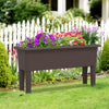 Raised garden bed in coffee color with flowers, featuring self-watering design and detachable legs for outdoor use.