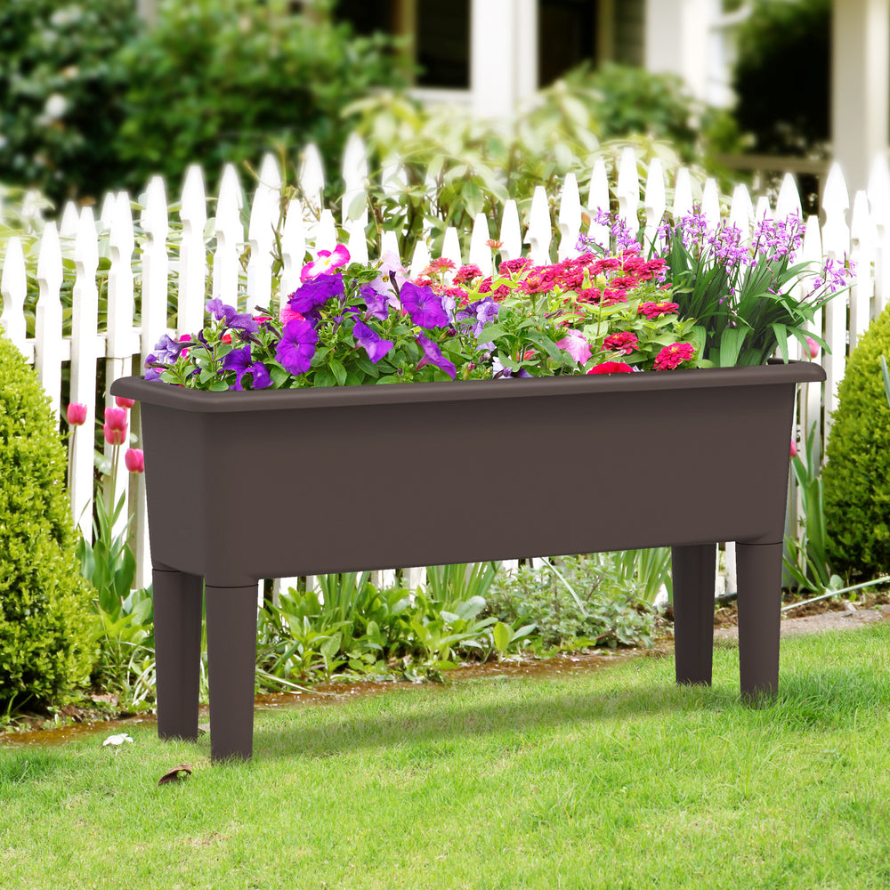Raised garden bed in coffee color with flowers, featuring self-watering design and detachable legs for outdoor use.