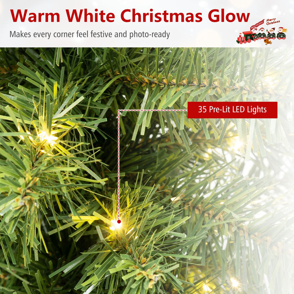 Close-up of a 24" pre-lit tabletop Christmas tree featuring 35 warm white LED lights and realistic PVC leaves.