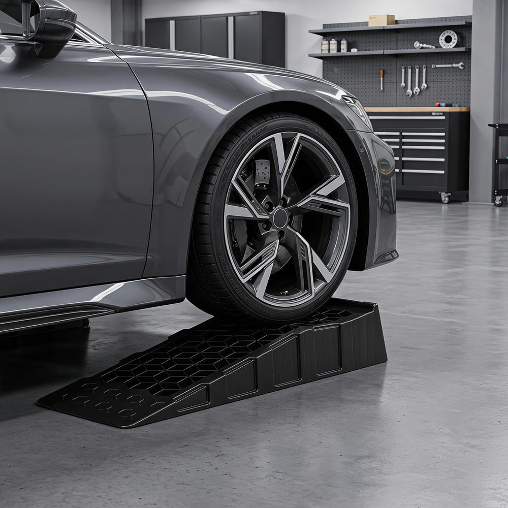 Low-profile car ramp set with a 2.5"/6.5 cm lift, designed for low-chassis vehicles, ideal for garage maintenance.