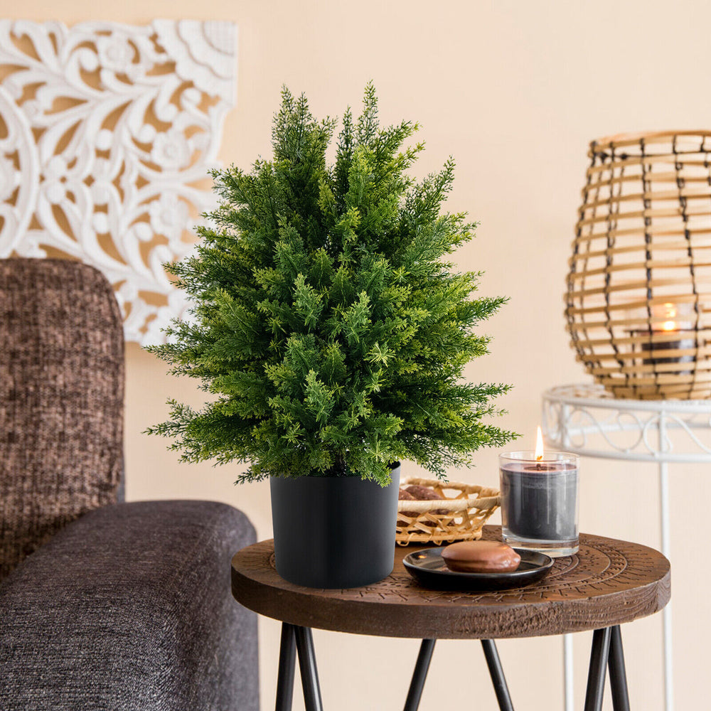 Artificial cedar topiary ball tree in a black pot, perfect for home decoration and easy maintenance in any room.