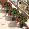 Artificial rose topiary ball trees in black cement-filled pots, featuring vibrant red roses and green leaves for.