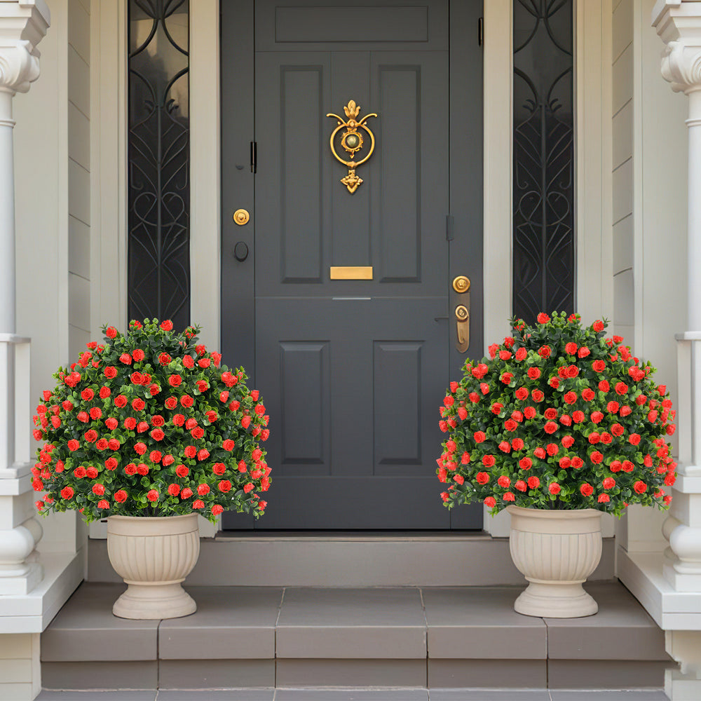 Two artificial rose topiary ball trees in decorative pots, featuring vibrant red flowers and lush green leaves for.