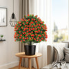 Artificial rose topiary ball tree with vivid red flowers and green leaves, perfect for home or office decor.