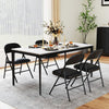 Black folding chairs with metal frame and PVC leather, featuring curved backrest, set for indoor dining or events.