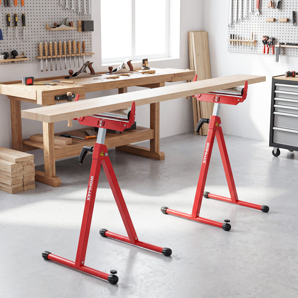 Folding roller stands in red with adjustable height, supporting heavy lumber feeding in a workshop setting.