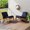 Two navy outdoor patio cushions with removable covers, crafted from breathable olefin fabric for comfortable relaxation.