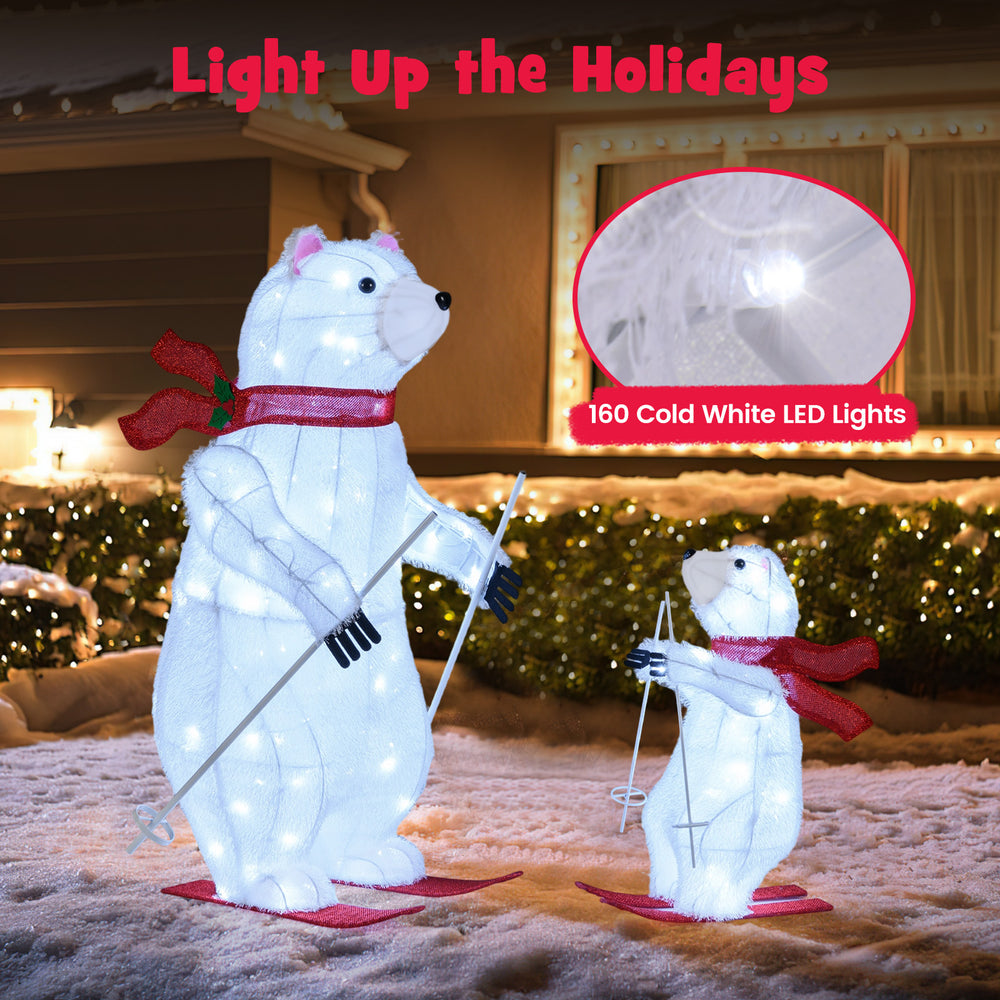 Animated skiing polar bears with 160 LED lights and red scarves, perfect for festive outdoor holiday displays.