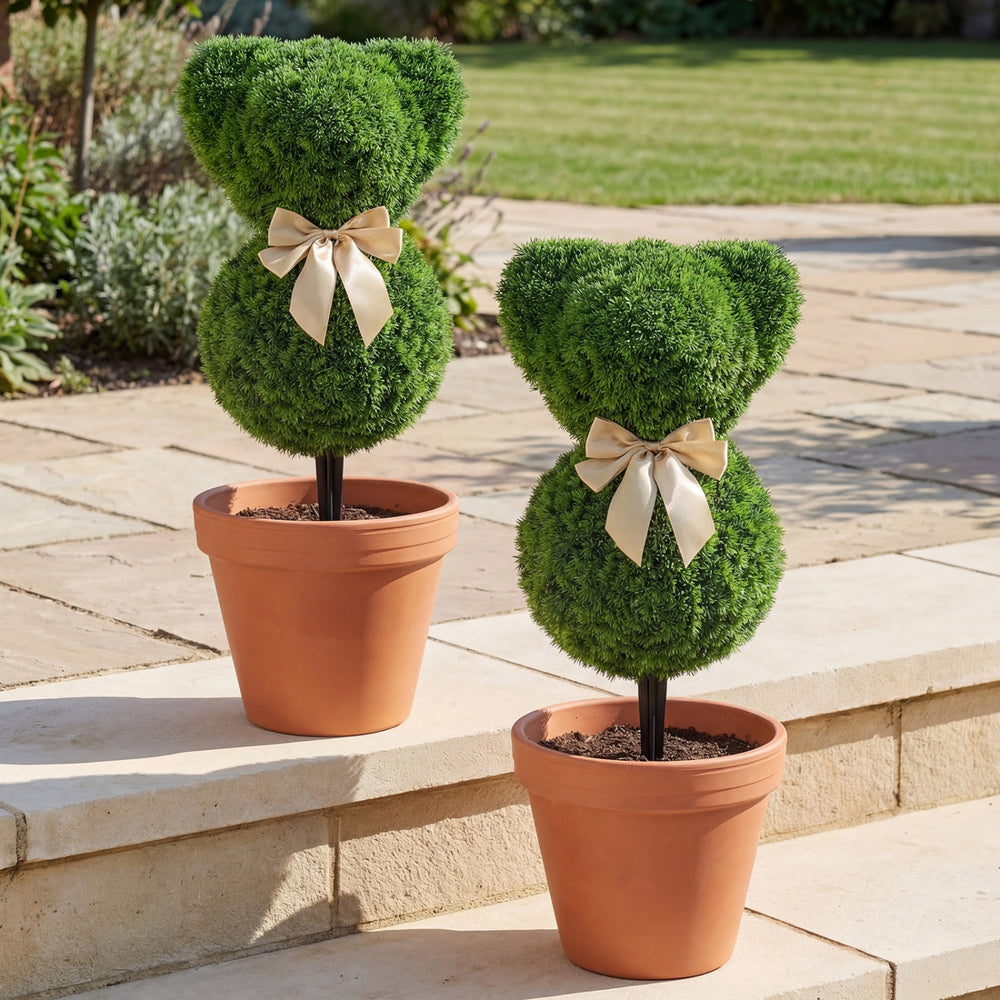 Teddy bear topiary trees with golden bows, made of sun-resistant faux boxwood, perfect for outdoor spring displays.