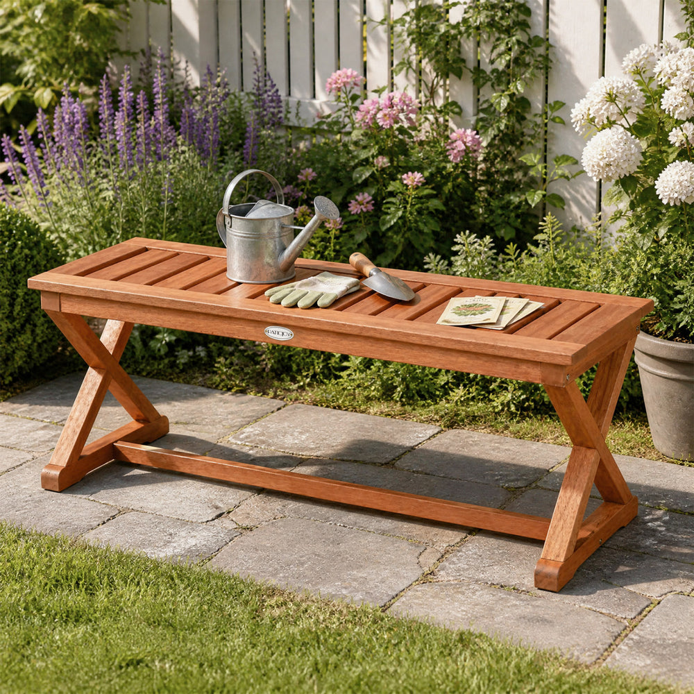 Outdoor bench with slatted seat and cross legs, crafted from hardwood with a teak finish, perfect for patio or garden use.