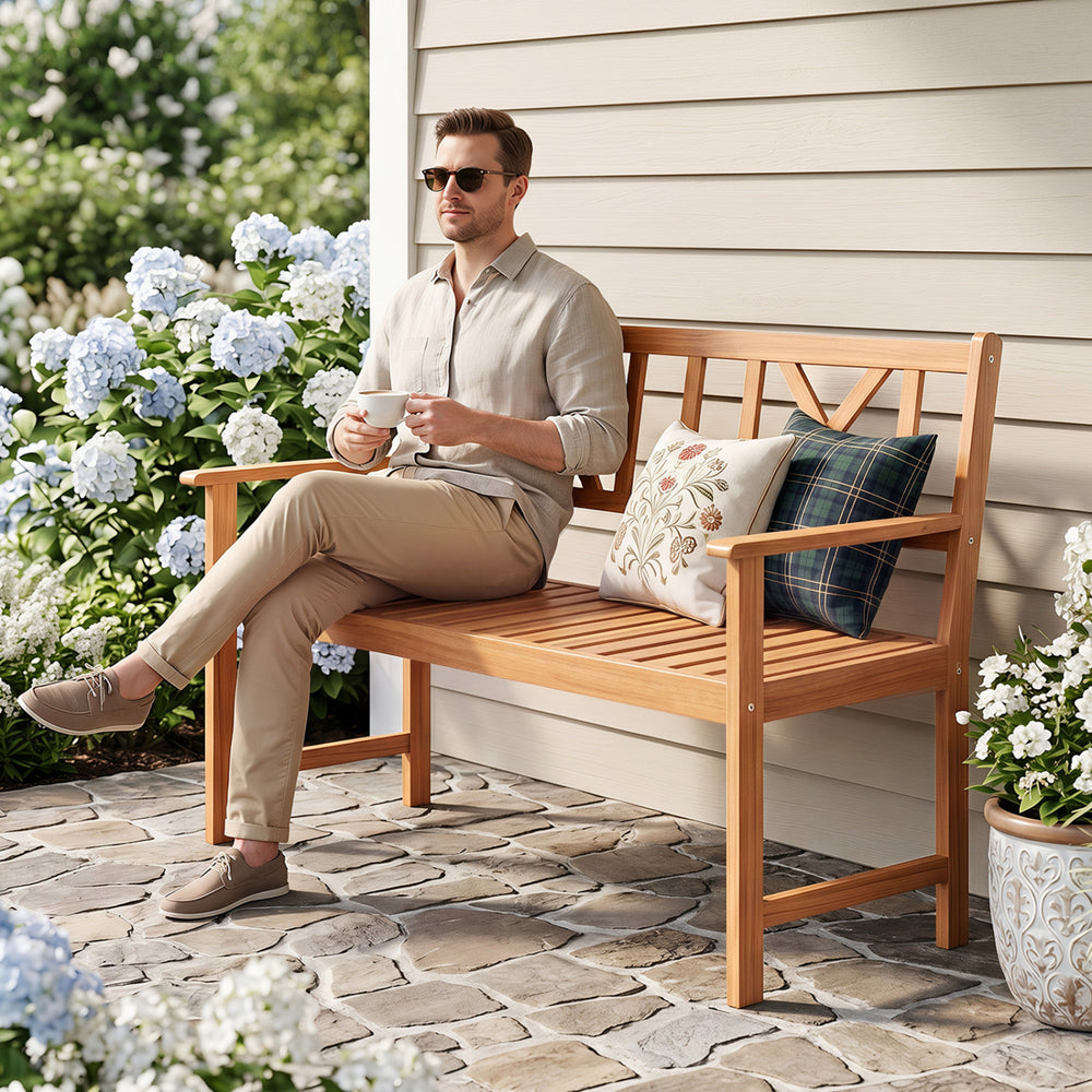 Acacia wood garden chair with armrests and X-shaped backrest, ideal for two people in outdoor settings like patios.