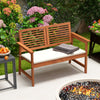 Solid wood patio bench with backrest and cushion, designed for two, perfect for backyard relaxation.