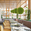Artificial sun-protective topiary spheres with vibrant boxwood leaves, ideal for patio or balcony decoration.