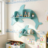 Blue floating dolphin shelves in a playful design, wall-mounted for organizing toys and books in a child's playroom.