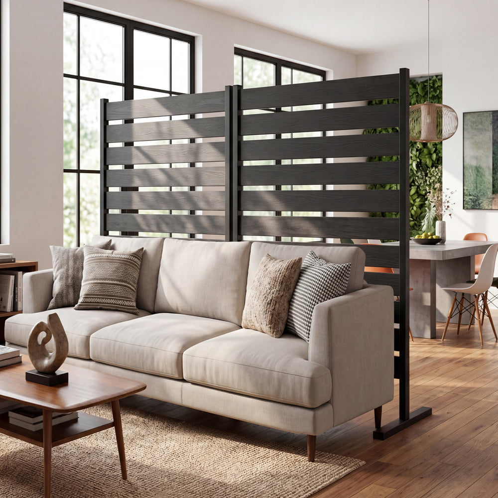 Freestanding gray outdoor privacy screen fence with slatted panels for airflow, ideal for backyard or patio use.