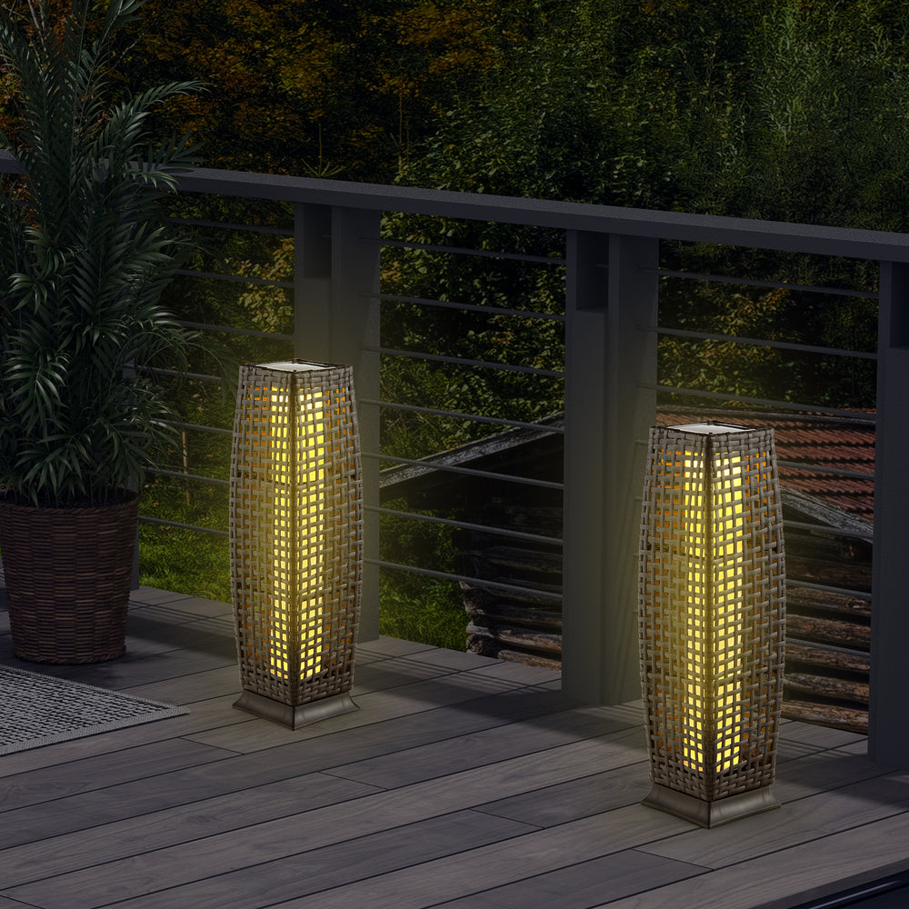 Two solar-powered wicker floor lamps in brown, providing warm yellow light for outdoor patio and garden use.