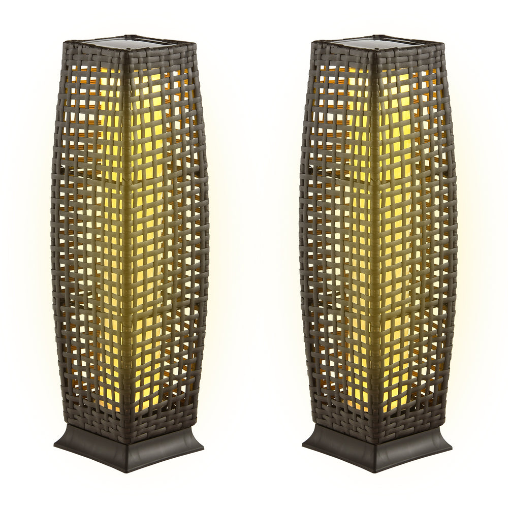 Two solar-powered square wicker floor lamps in light brown, providing warm yellow light for outdoor use.