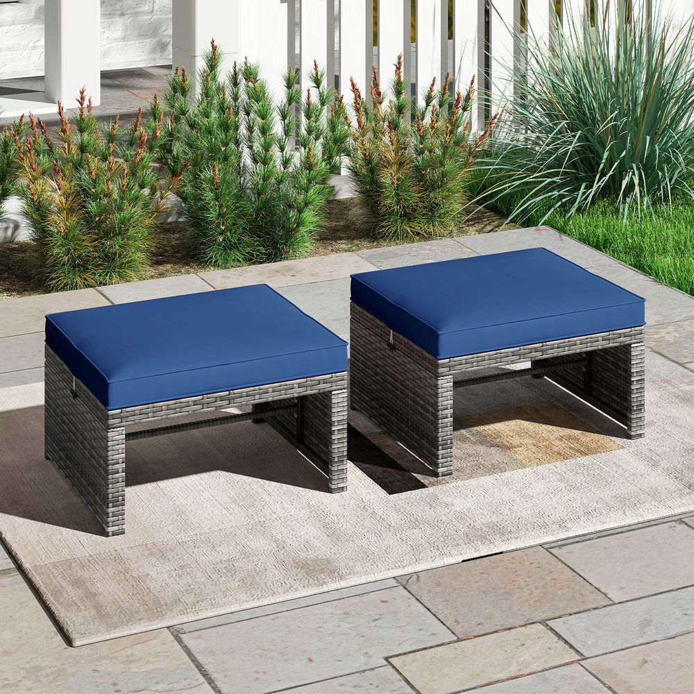 Two navy blue PE rattan ottomans with soft zippered cushions, ideal for outdoor seating or as coffee tables on the.