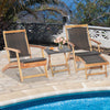Two folding lounge chairs with retractable ottoman and acacia wood table, perfect for poolside relaxation.