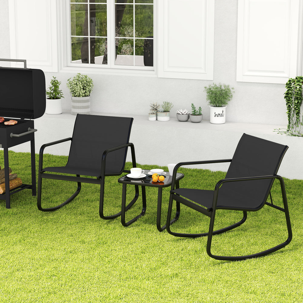 Black rocking bistro chairs positioned near a glass-top table, ideal for enjoying drinks in your backyard or on the.