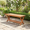 2-seat wooden garden patio bench with X-shaped legs, placed in a lush garden setting for outdoor relaxation.