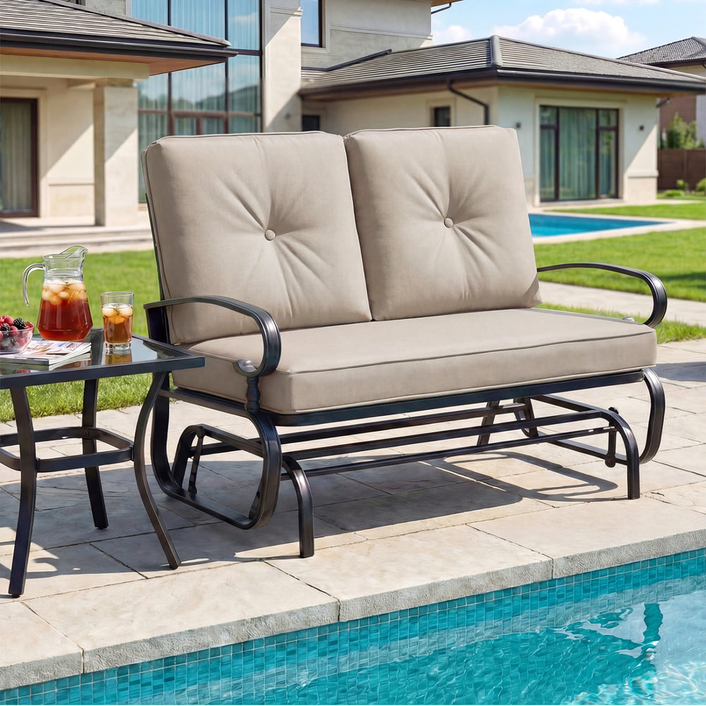 Beige outdoor swing glider chair with cozy cushions and curved armrests, ideal for two-person relaxation on the patio.