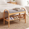 Bamboo shoe bench with gray padded cushion and slatted shelf, ideal for entryway or bedroom seating and shoe storage.