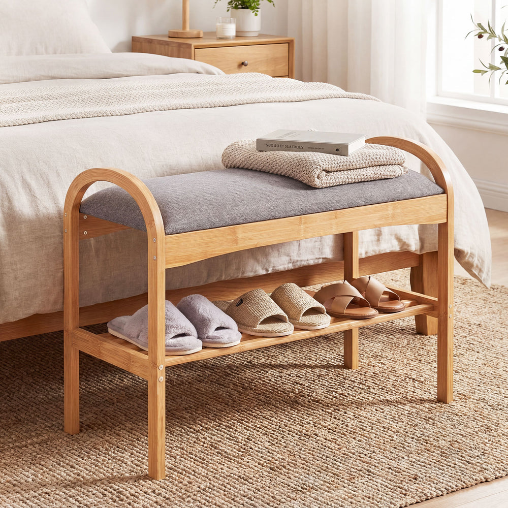 Bamboo shoe bench with gray padded cushion and slatted shelf, ideal for entryway or bedroom seating and shoe storage.