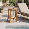 Natural eucalyptus wood side table with slatted tabletop and storage shelf, perfect for outdoor patio or poolside use.