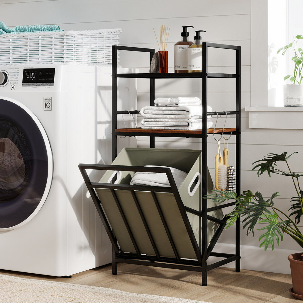 2-tier laundry hamper with tilt-out basket in black, featuring shelves for towels and storage near a washing machine.