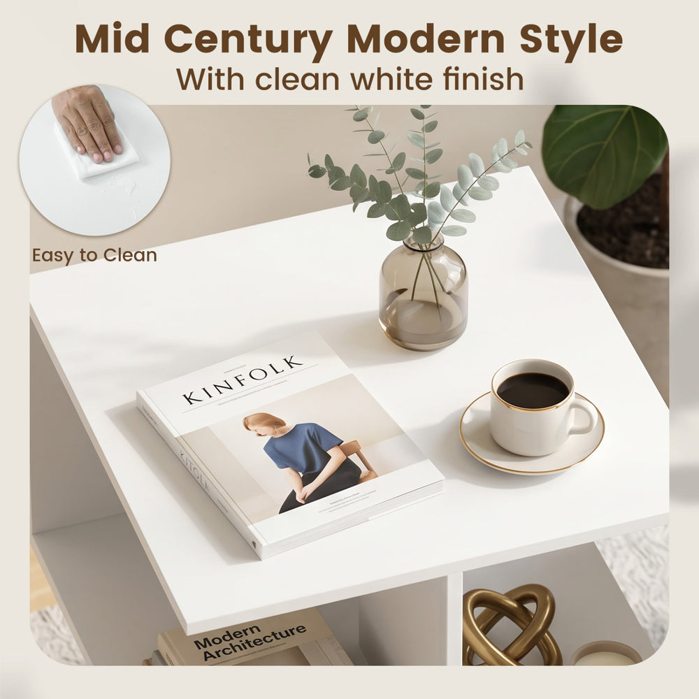 Square white end table with 2 tiers and raised metal legs, perfect for living rooms or bedrooms with a mid-century modern style.