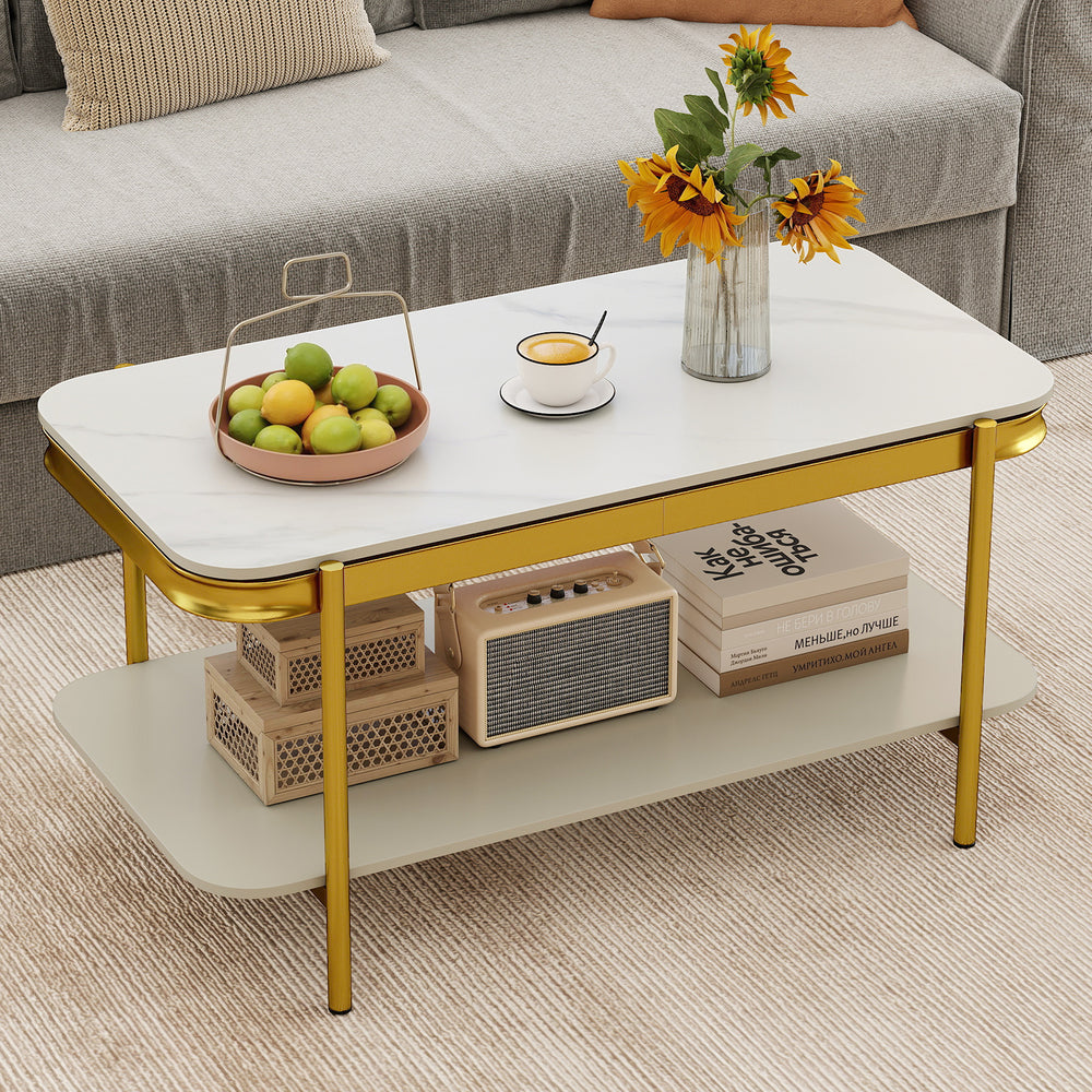 Modern rectangular coffee table with a white sintered stone top and gold metal frame, featuring an open storage shelf.