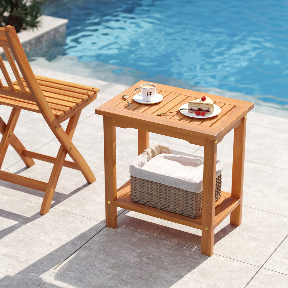 2-tier outdoor acacia wood side table with slatted tabletop and storage shelf, perfect for patio or poolside use.