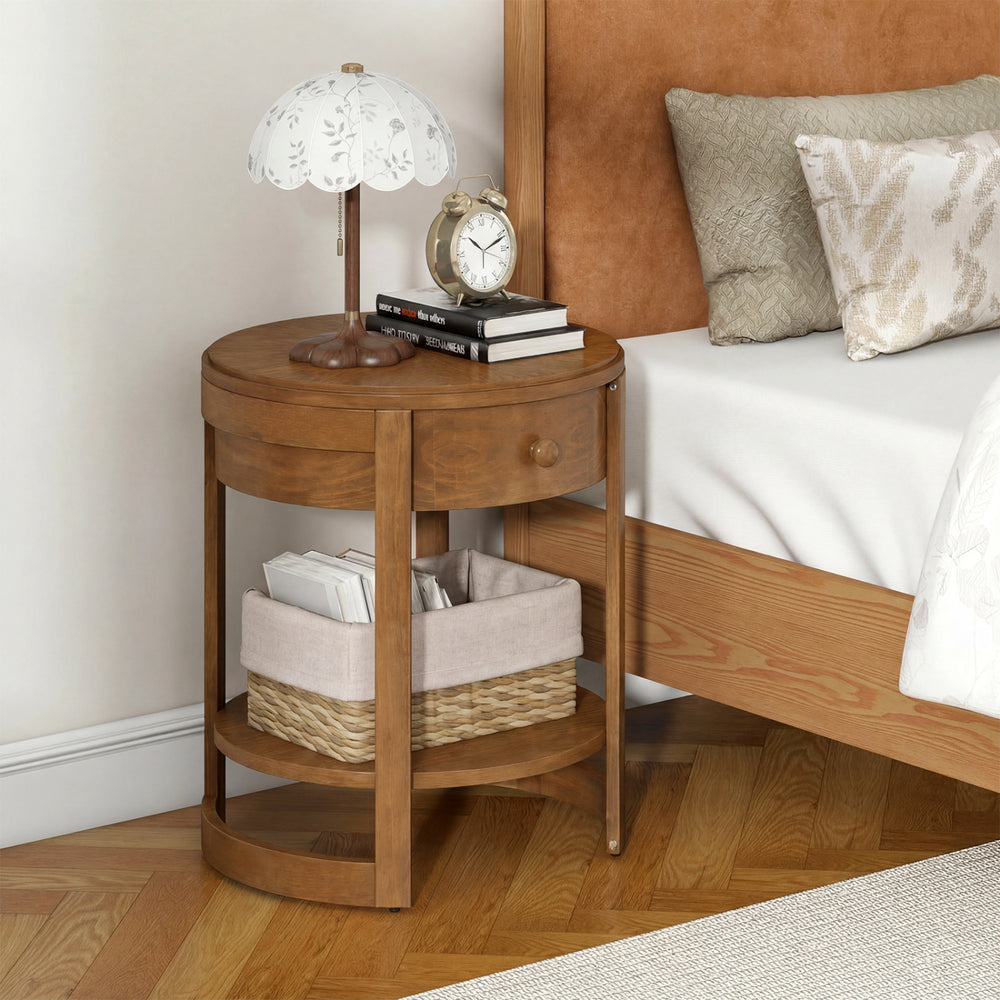 Round end table with oak finish, featuring a drawer and lower shelf, ideal for mid-century modern bedroom decor.