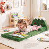 Convertible kids sofa in green with Christmas patterns, shown as a lounger for reading in a cozy playroom setting.