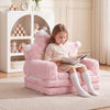 Foldable pink kids sofa bed with removable slipcover, perfect for reading and lounging in a cozy space.