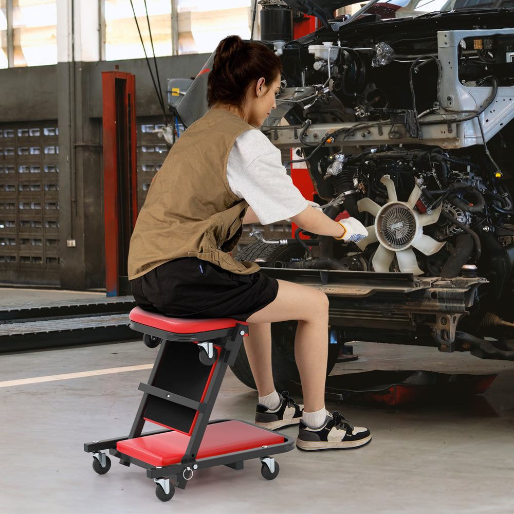 Low profile mechanic creeper in red, convertible stool design with padded seat and 6 wheels for garage use.