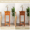 Slim brown nightstand with drawer and shelf, made of acacia wood, shown in bright and dim lighting conditions.